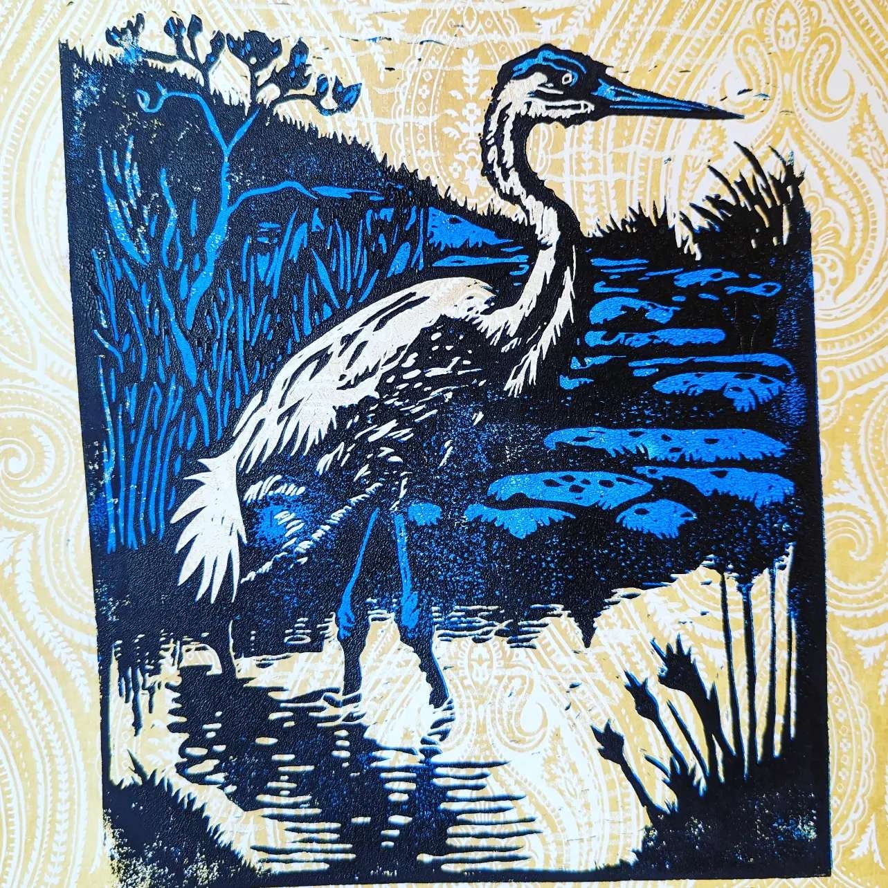 blue white black heron linocut print on wallpaper