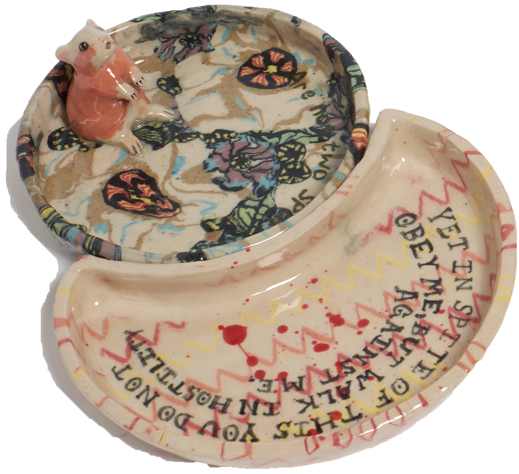 close up of guinea pig ashtray with floral detail and firey chevron pattern